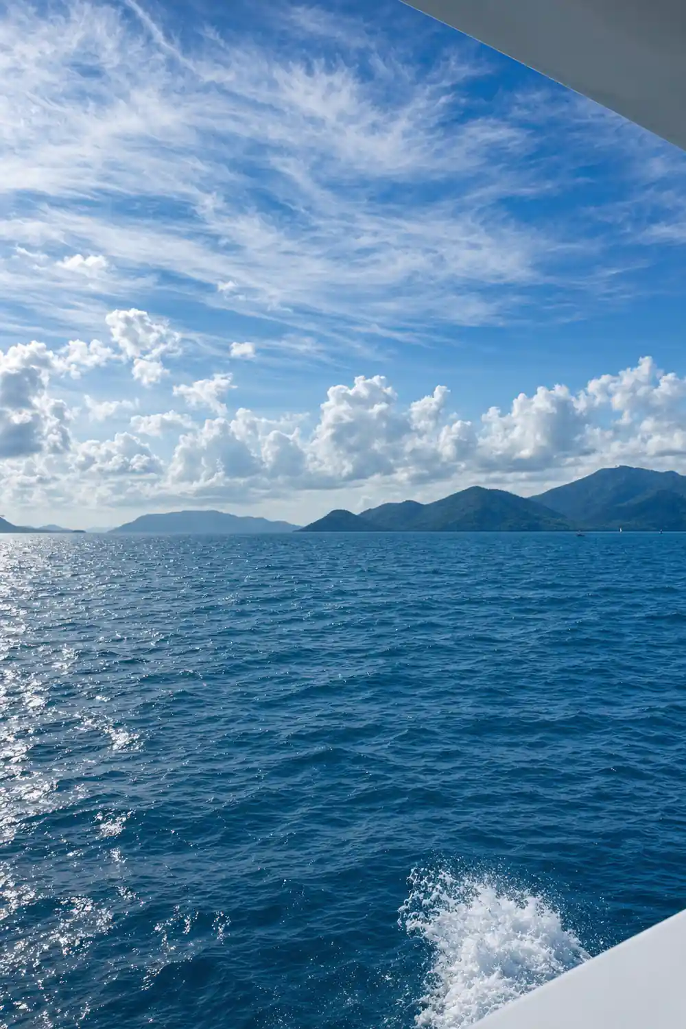 An island on the horizon under building cloud